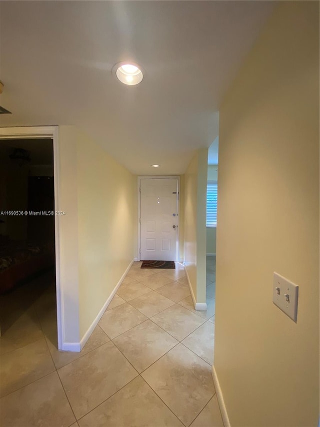 corridor featuring light tile patterned floors