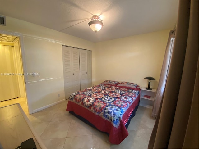 bedroom featuring a closet and light tile patterned floors