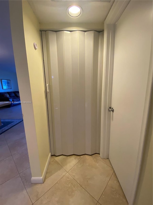 hallway featuring light tile patterned floors