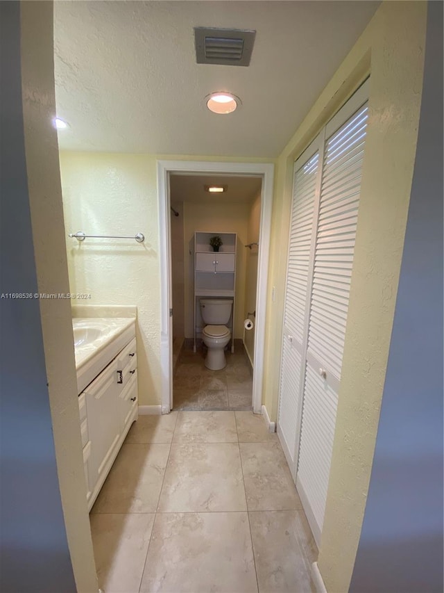 bathroom with tile patterned floors, vanity, and toilet