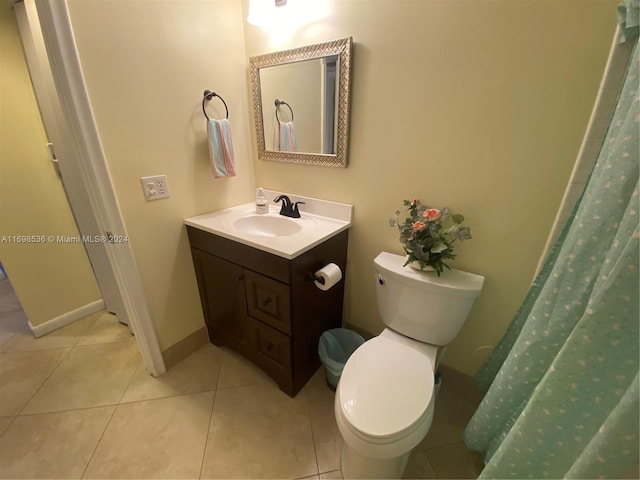 bathroom featuring tile patterned flooring, vanity, and toilet