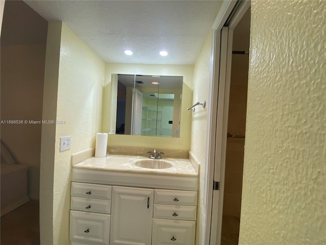 bathroom with vanity and a textured ceiling