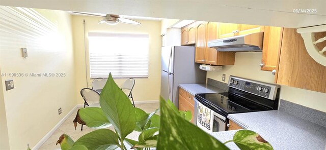 901 SW 128th Ter Unit 103A, Pembroke Pines, FL 33027 - kitchen with stainless steel electric stove, under cabinet range hood, freestanding refrigerator, a ceiling fan, and light tile patterned floors