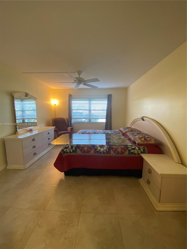 bedroom with ceiling fan and light tile patterned floors