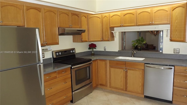 901 SW 128th Ter Unit 103A, Pembroke Pines, FL 33027 - kitchen with stainless steel appliances, under cabinet range hood, light tile patterned floors, and dark countertops
