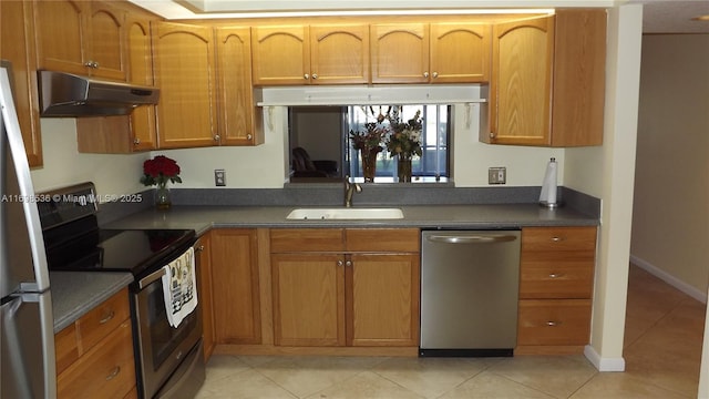 901 SW 128th Ter Unit 103A, Pembroke Pines, FL 33027 - kitchen with stainless steel appliances, under cabinet range hood, dark countertops, light tile patterned floors, and brown cabinetry