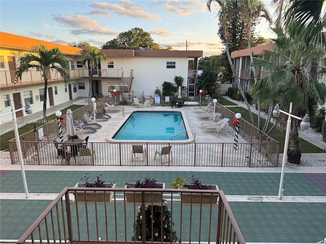 view of pool at dusk