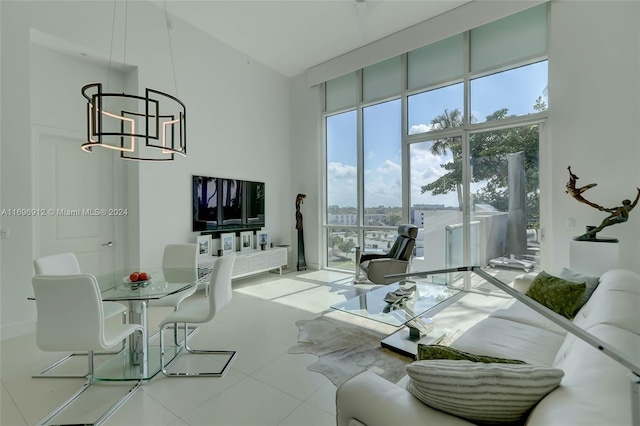 living room with a chandelier and a towering ceiling