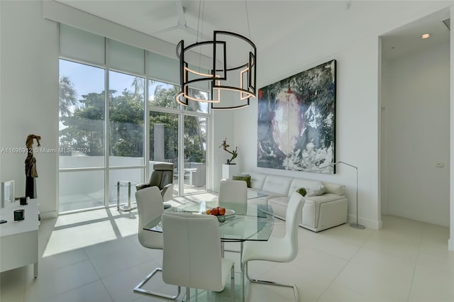 dining room featuring light tile patterned floors and an inviting chandelier