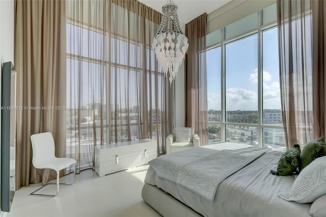 bedroom featuring multiple windows and a notable chandelier