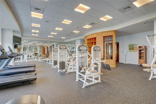 exercise room featuring a paneled ceiling