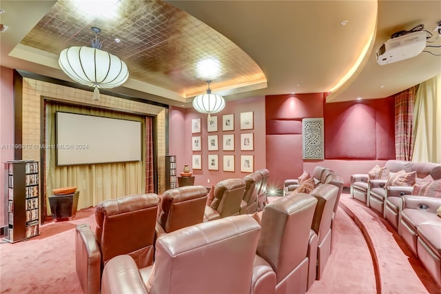 cinema room with carpet floors and a tray ceiling