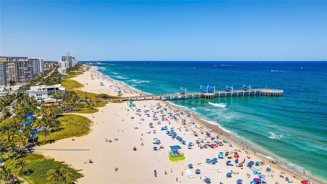 bird's eye view featuring a view of the beach and a water view