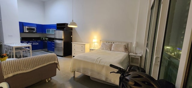 bedroom featuring stainless steel fridge