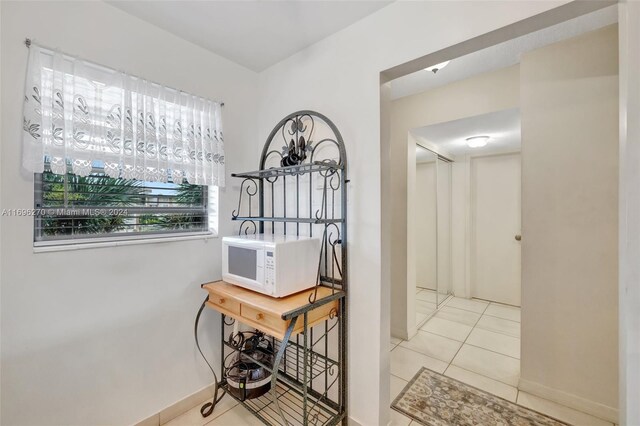 hallway with light tile patterned flooring