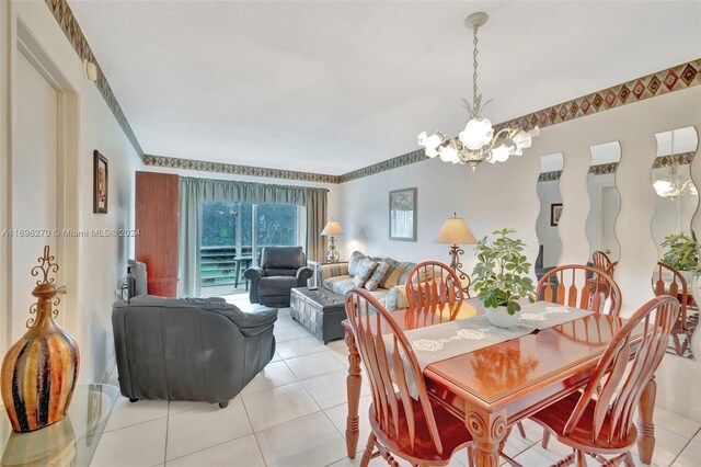 tiled dining room with a chandelier