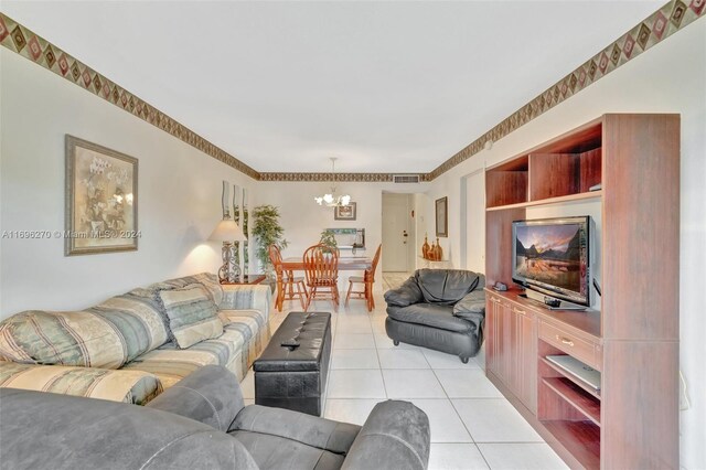 living room featuring a chandelier and light tile patterned floors