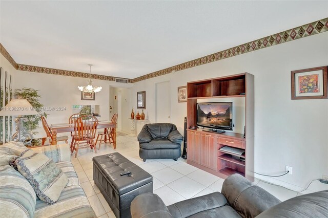 living room with light tile patterned floors and an inviting chandelier