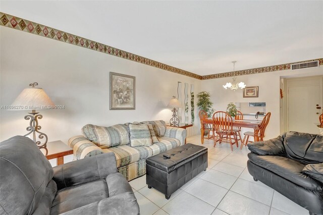 living room featuring light tile patterned floors and an inviting chandelier