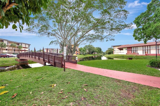 view of community featuring a yard and a water view