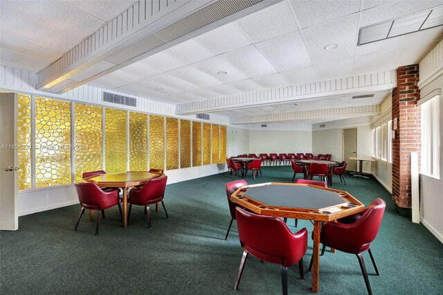 rec room with a paneled ceiling and carpet floors