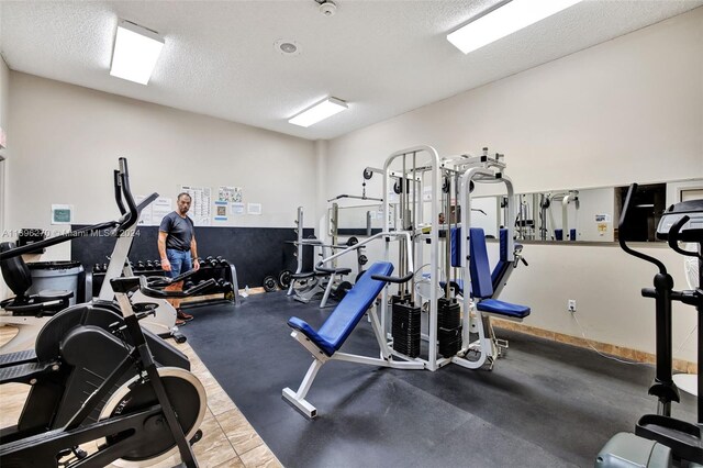 exercise room with a textured ceiling