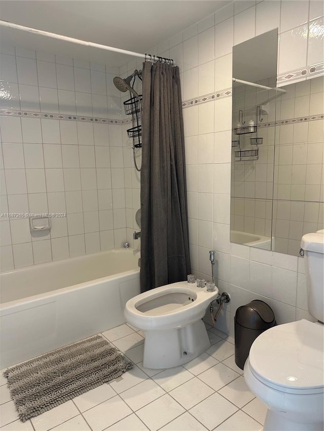 bathroom featuring a bidet, tile patterned floors, shower / bath combination with curtain, toilet, and tile walls