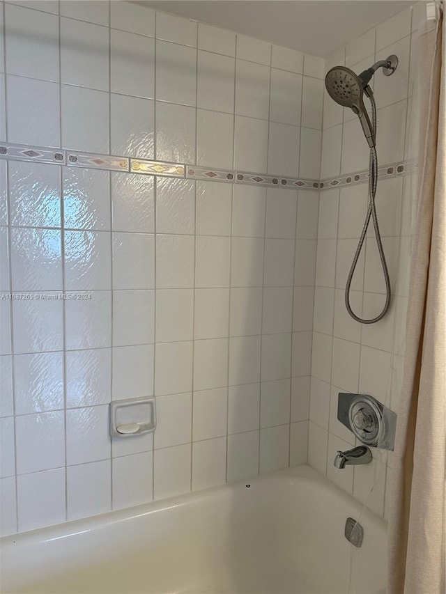 bathroom with shower / bath combination with curtain