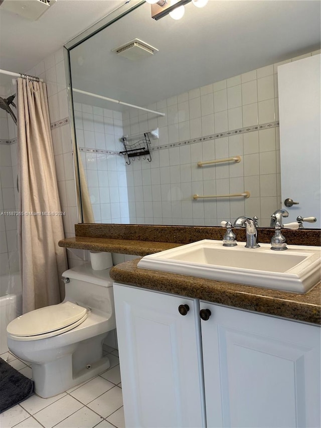 full bathroom with tile patterned floors, vanity, toilet, and shower / tub combo