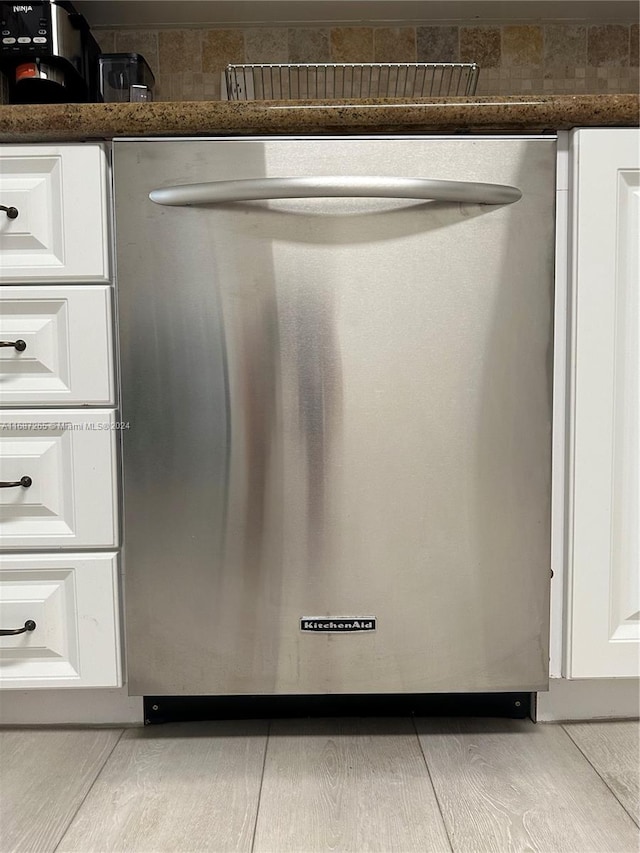 room details featuring white cabinetry and stainless steel dishwasher