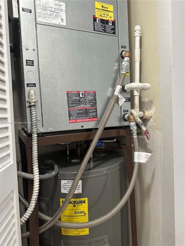 utility room with heating unit and water heater