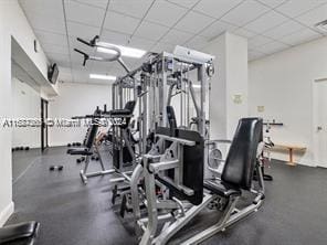 gym with a paneled ceiling