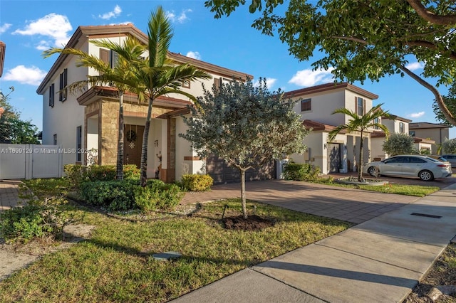 mediterranean / spanish-style house with a front yard