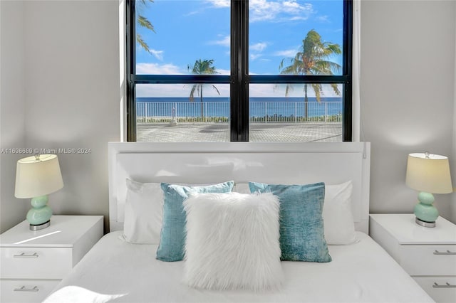 bedroom featuring a water view