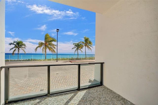 balcony featuring a water view and a view of the beach