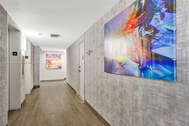 hallway with wood-type flooring