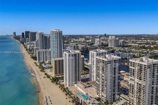 drone / aerial view featuring a water view and a view of the beach