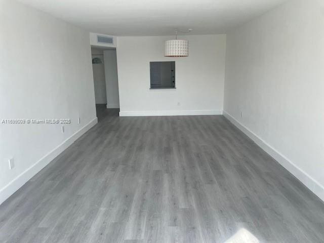 spare room with dark hardwood / wood-style flooring