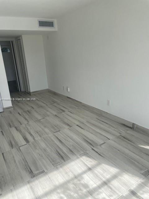 spare room featuring light wood-type flooring