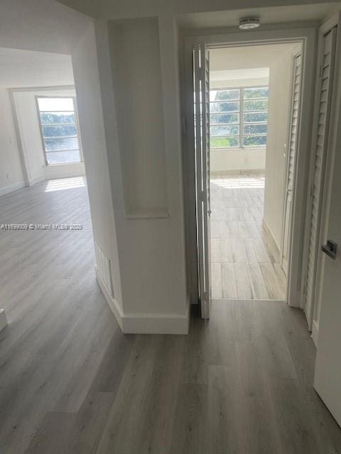 corridor with light hardwood / wood-style floors