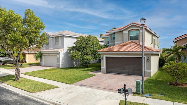 view of front facade featuring a garage and a front lawn