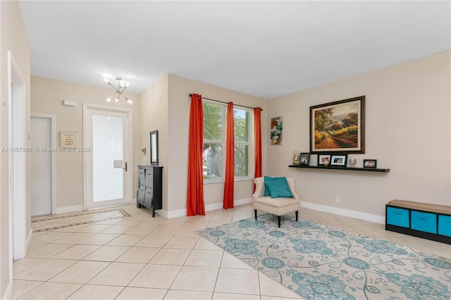 living area with a notable chandelier and light tile patterned flooring