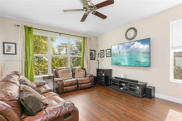 living room featuring a wealth of natural light, dark wood-type flooring, and ceiling fan