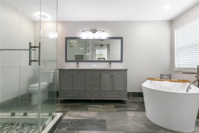 full bathroom with vanity, separate shower and tub, and toilet