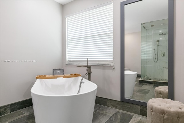 bathroom featuring shower with separate bathtub and plenty of natural light