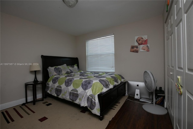 bedroom featuring hardwood / wood-style flooring and a closet