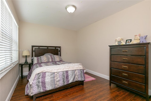 bedroom with dark hardwood / wood-style flooring