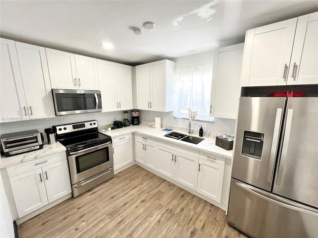 kitchen with white cabinetry, sink, and appliances with stainless steel finishes