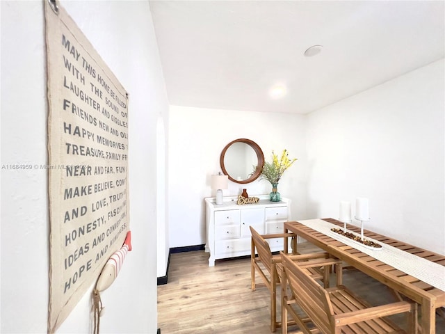 dining space with wood-type flooring