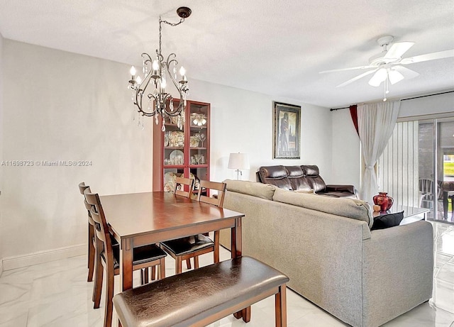 dining room with a textured ceiling and ceiling fan with notable chandelier